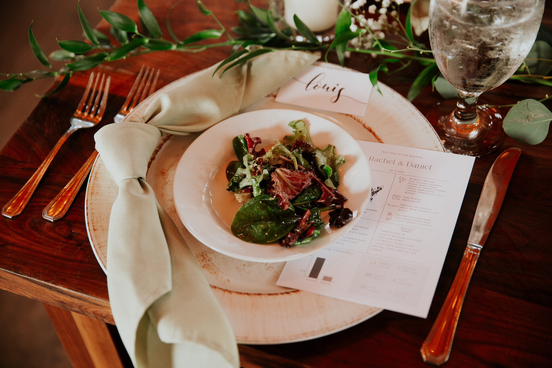 A place setting, the menu folded beside it